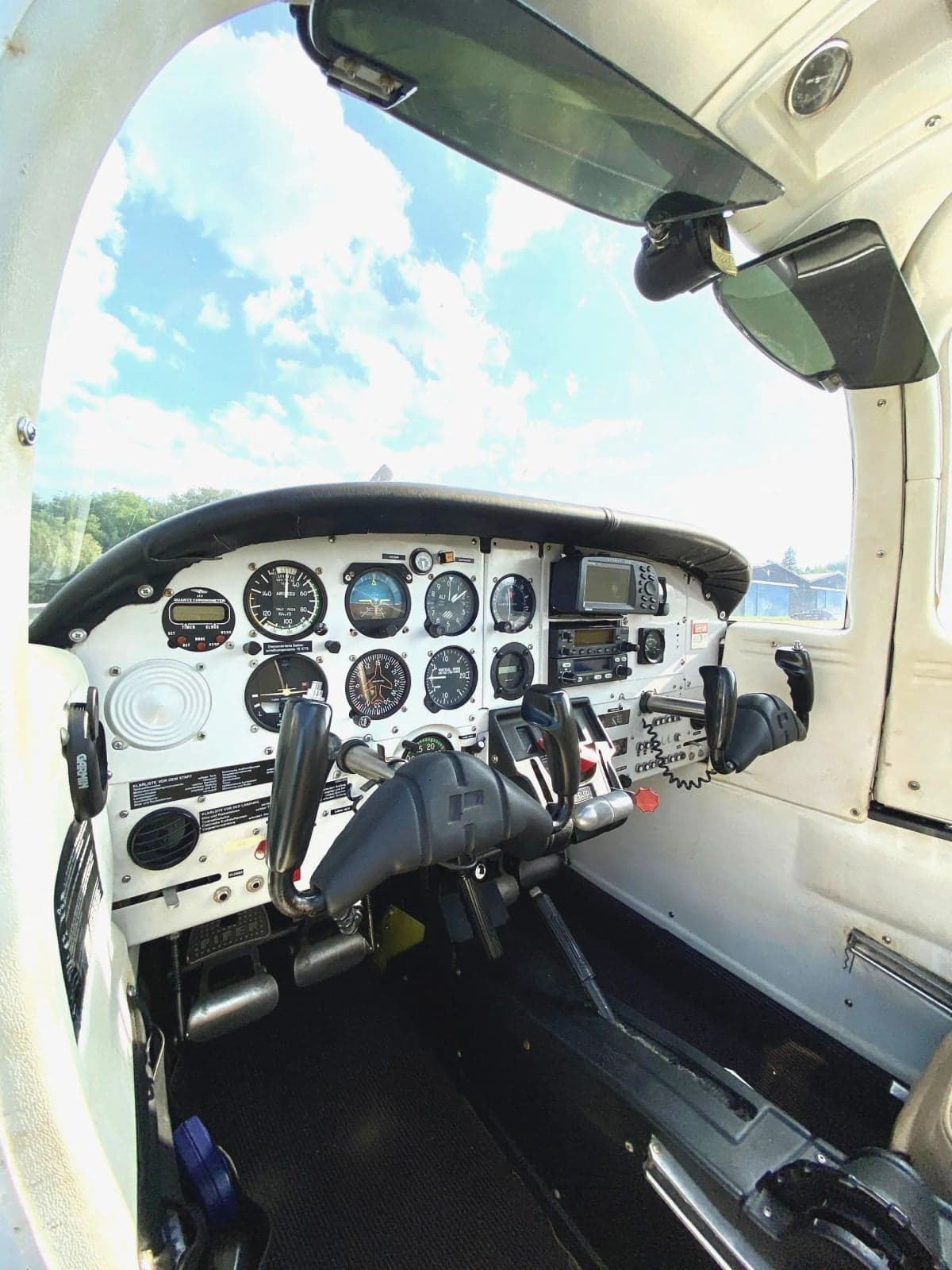 View of the cockpit of the D-ELCD aircraft with the door open.