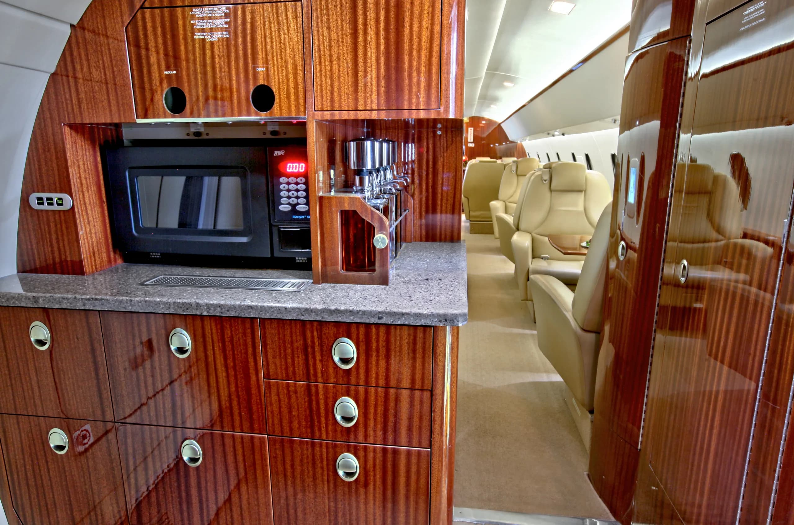 View of the aircraft's interior cabin with a galley area and seating.