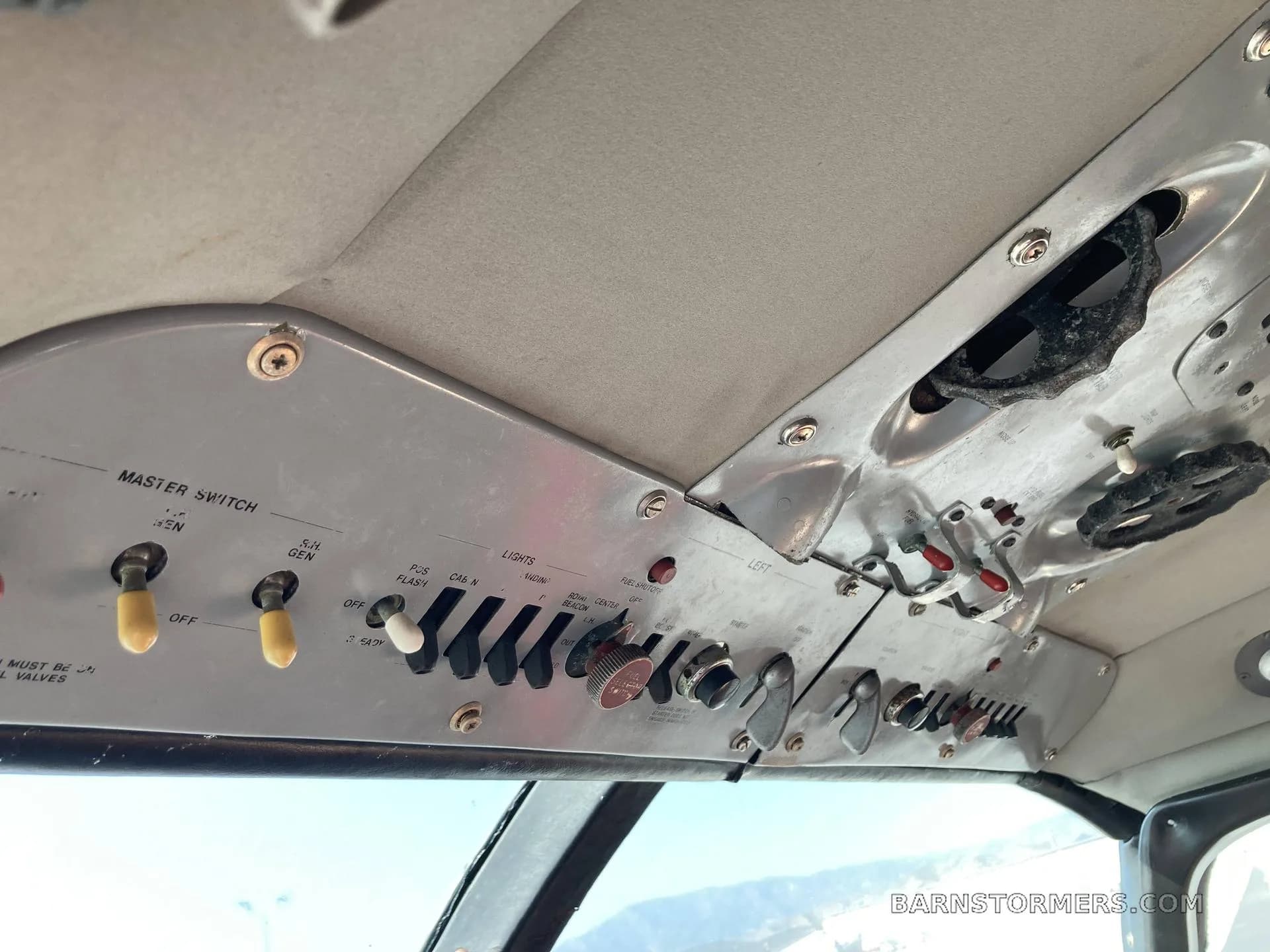 An overhead view of the master switch and other control switches in an aircraft cockpit.