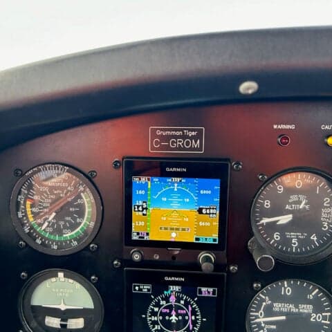 Close-up of the instrument panel of a Grumman Tiger, showing the Garmin avionics.