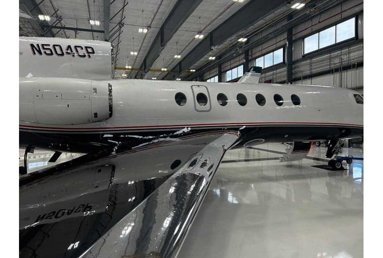Side view of the N504CP aircraft in a hangar.
