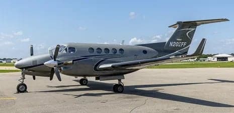 Side view of a gray King Air aircraft on the tarmac.