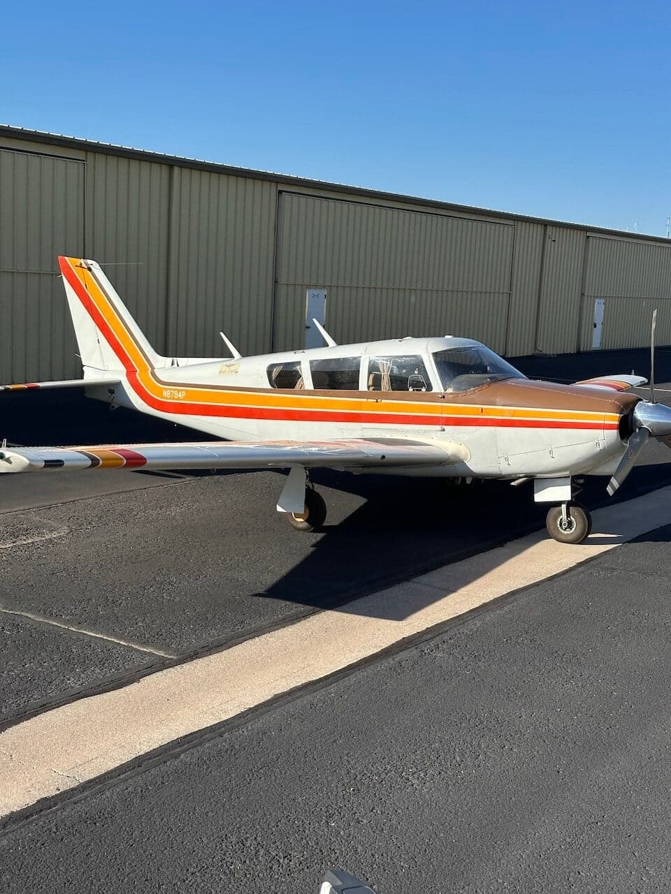 Side view of a Piper PA-28-181 Archer II aircraft on the tarmac.