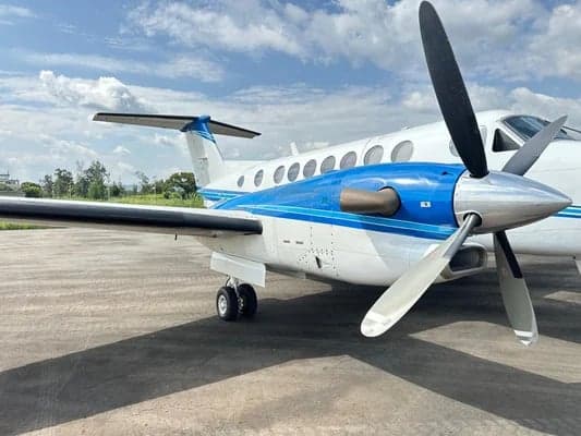Close-up of the King Air aircraft's propeller and nose, with the rest of the aircraft in the background.