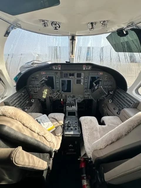 View of the aircraft cockpit with sheepskin seat covers.
