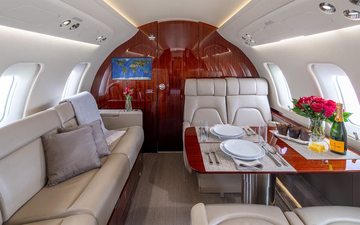 Challenger interior with a couch, table, and roses.
