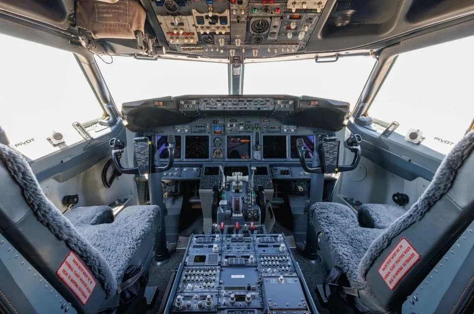 The cockpit of a Boeing 737, showing the instrument panel, yokes, and center console.