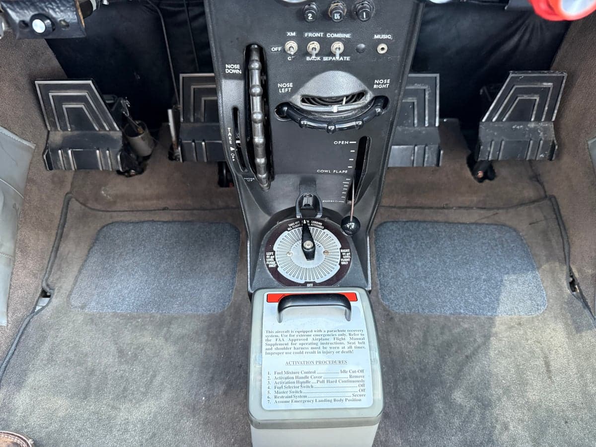 Rudder pedals and parachute activation instructions in the cockpit of N303BS.