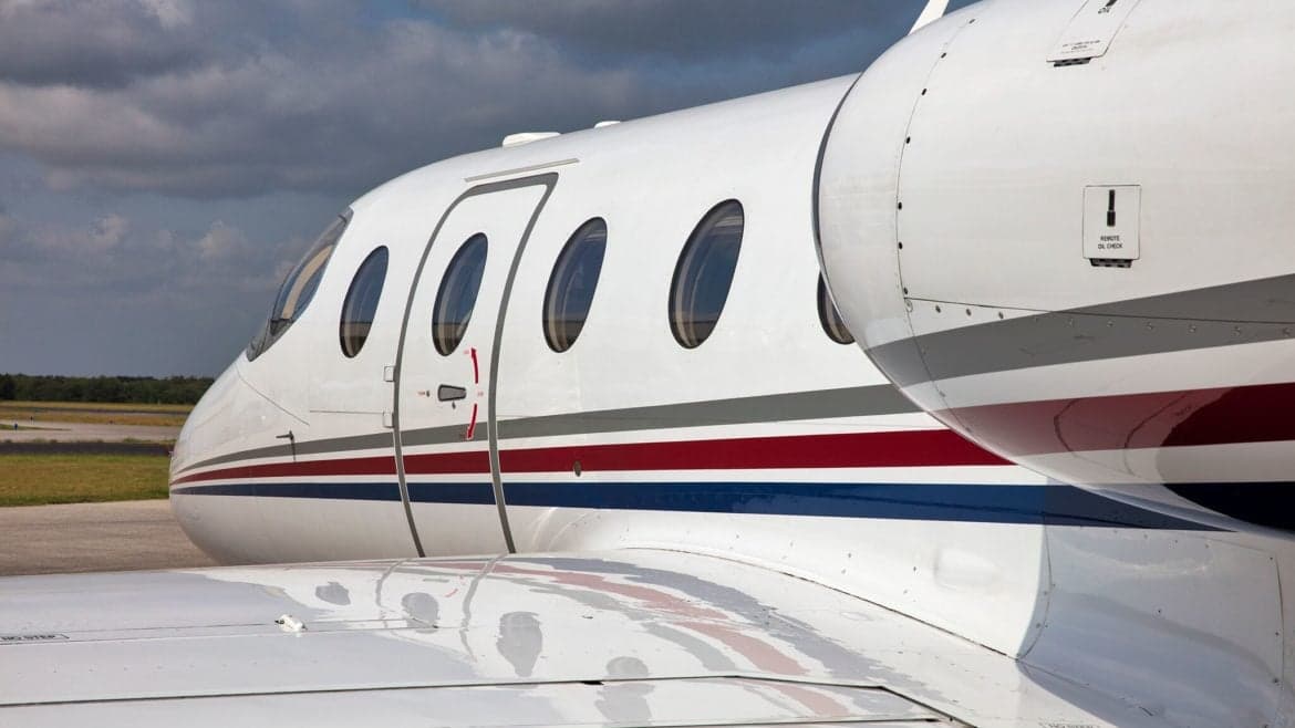 Close up of the fuselage and wing of the aircraft, showing the paint scheme.
