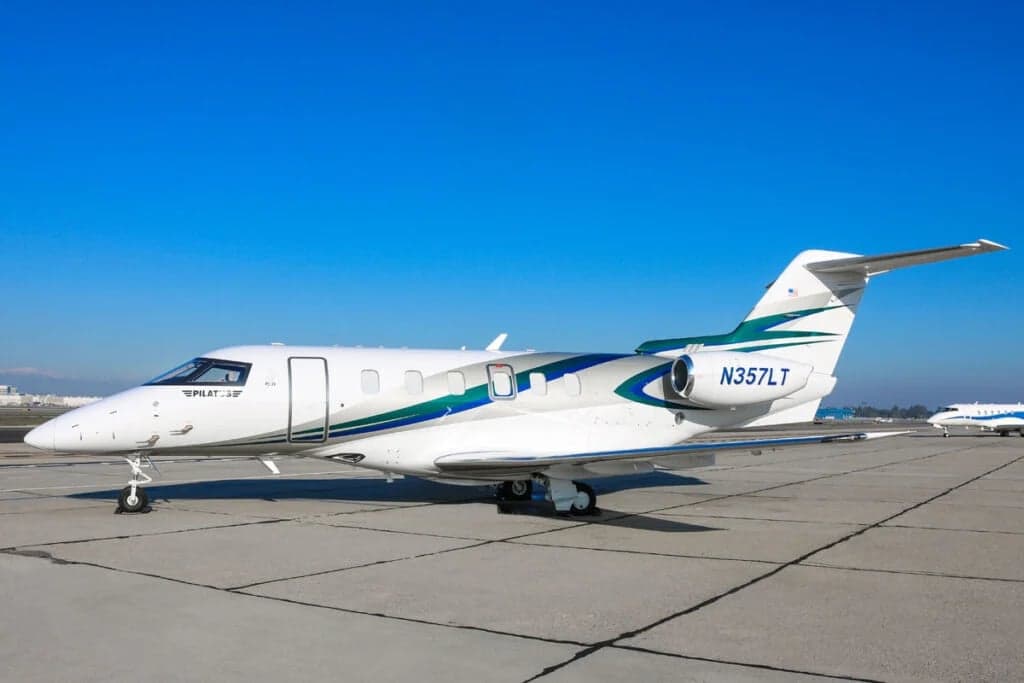 Pilatus PC-24 N357LT parked on the tarmac with a white and teal paint scheme.
