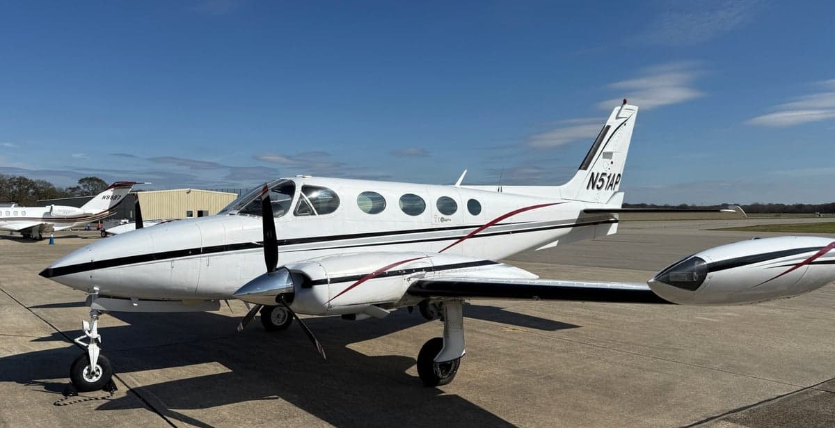 Side view of the Cessna 340A aircraft with registration N51AP parked on the tarmac.