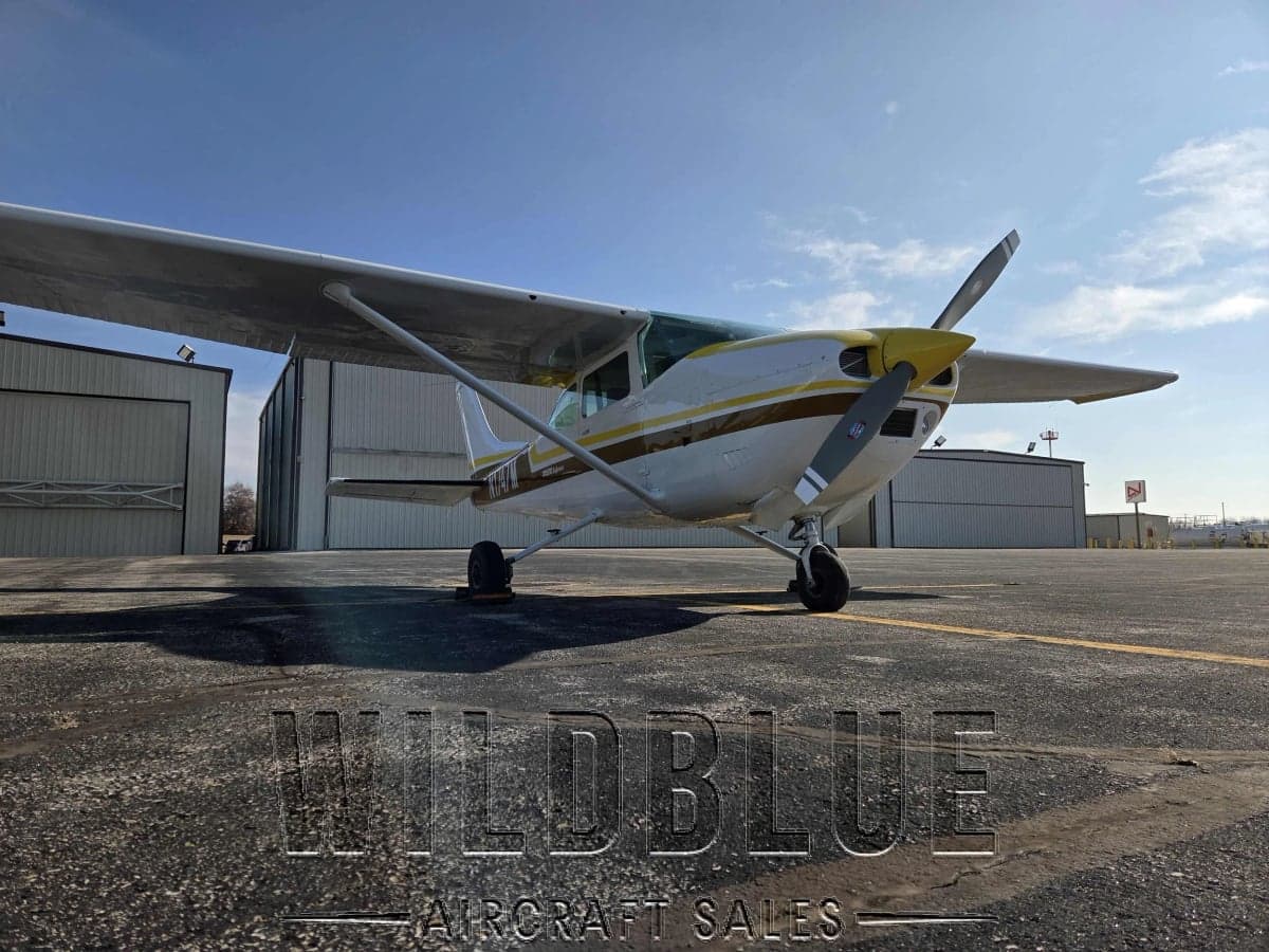 N1747M Cessna Skyhawk with white and gold paint scheme on the tarmac with Wildblue Aircraft Sales watermark.