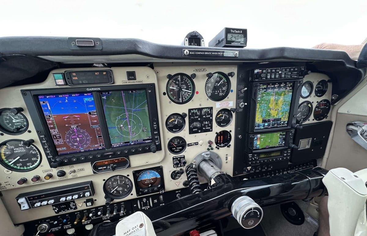 The cockpit of a Beechcraft Bonanza with a mix of analog and digital instruments.