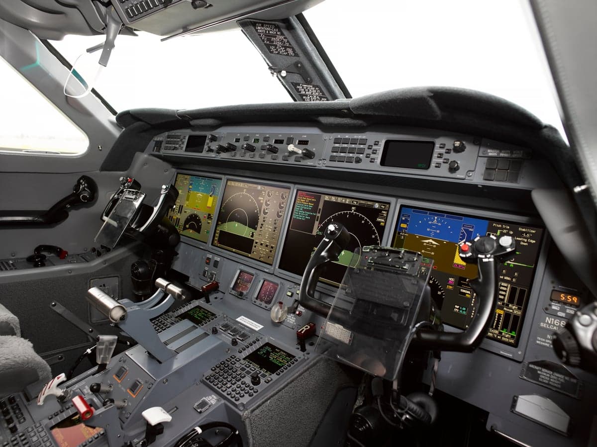 View of the aircraft's cockpit featuring multiple display screens and controls.