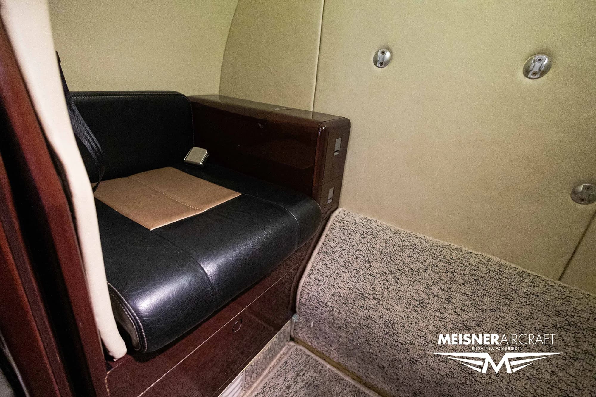 Close up of the aircraft interior showing a seat and side panel.