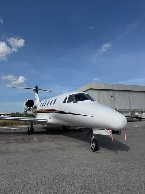 Cessna Citation CJ3+ on the tarmac in front of a hangar.