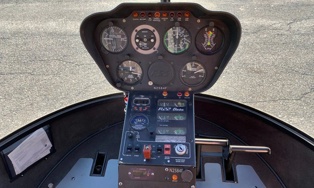 Close-up of the instrument panel and controls of a Robinson R22 Beta helicopter, registration N2584F.