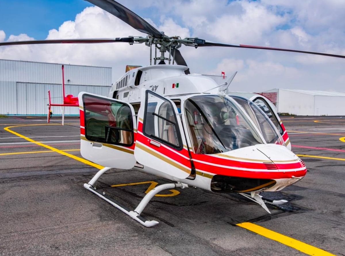 Front quarter view of a Bell 407 helicopter with the doors open.