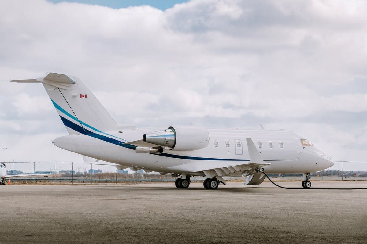 A Challenger aircraft with a white and blue paint scheme on the tarmac.