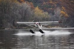A float plane takes off from the water.