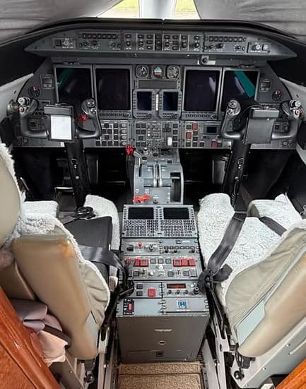View of the Learjet's cockpit instrument panel and seats.