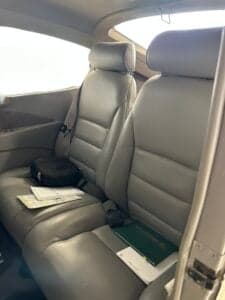 Rear seats of the Cessna 172 Skyhawk with gray leather upholstery.