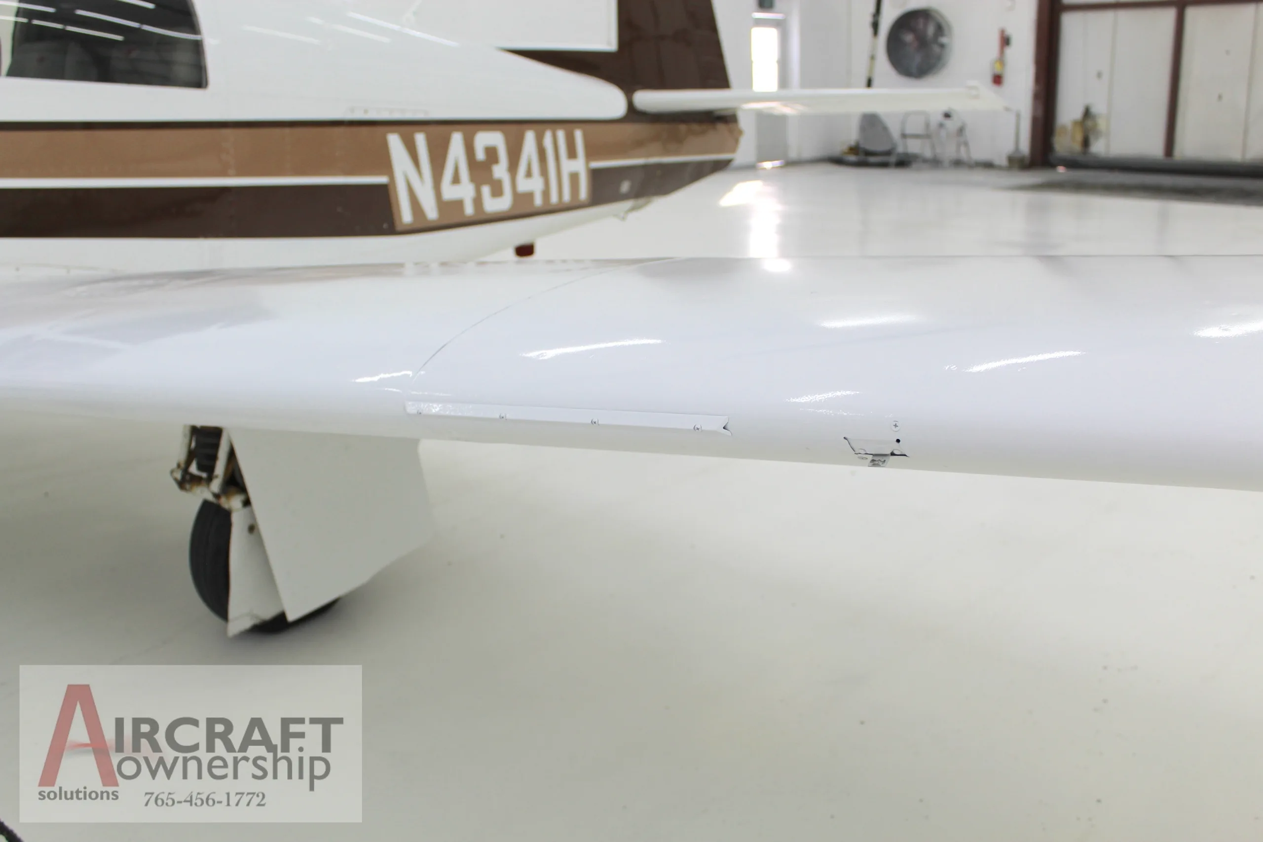Close-up of the wing of a Mooney M20J aircraft with registration N4341H.
