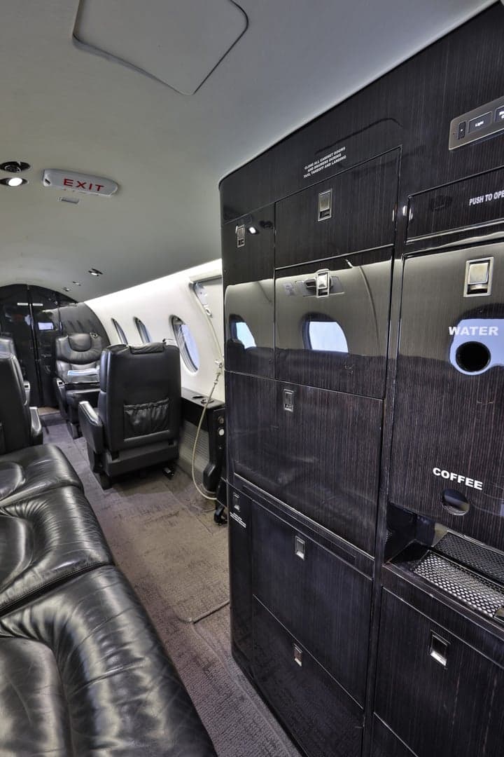 The Hawker 400XP cabin includes a refreshment center with coffee and water service.