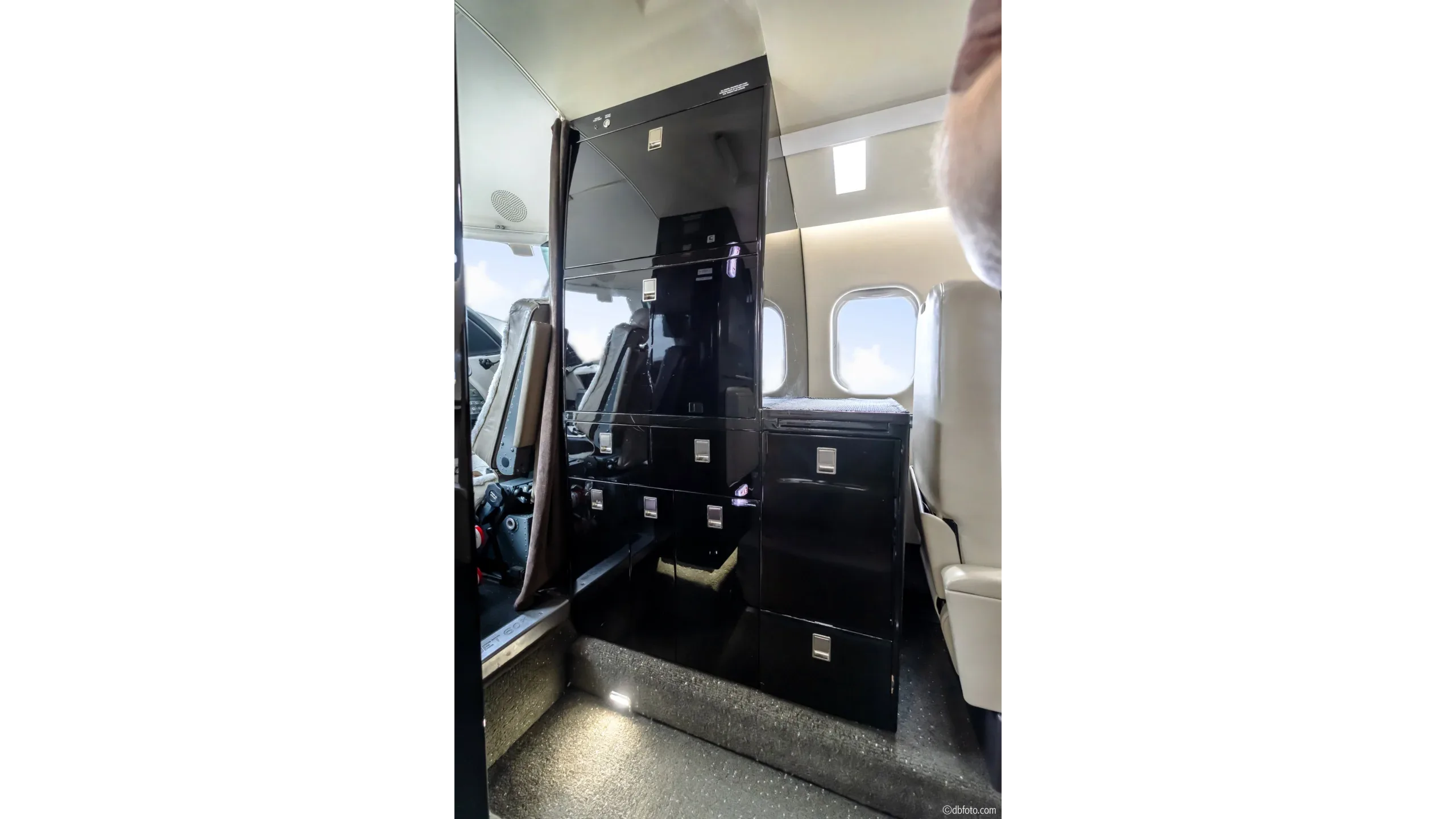 View of the aircraft interior with storage and seating.