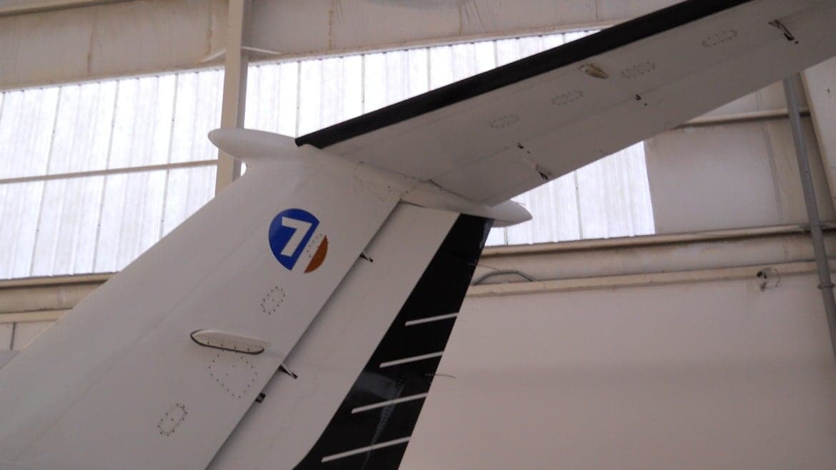 The tail of a Beechcraft King Air shows the tail number and a circular logo.