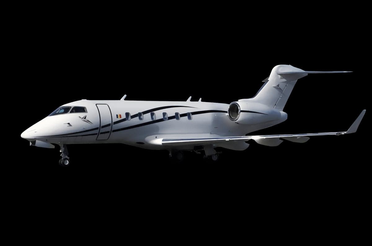 A white Bombardier Challenger jet with black stripes on a black background.