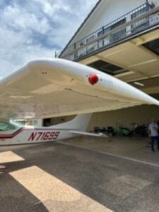 Side view of a Cessna 182 Skylane, registration N71699, parked under a covered area.