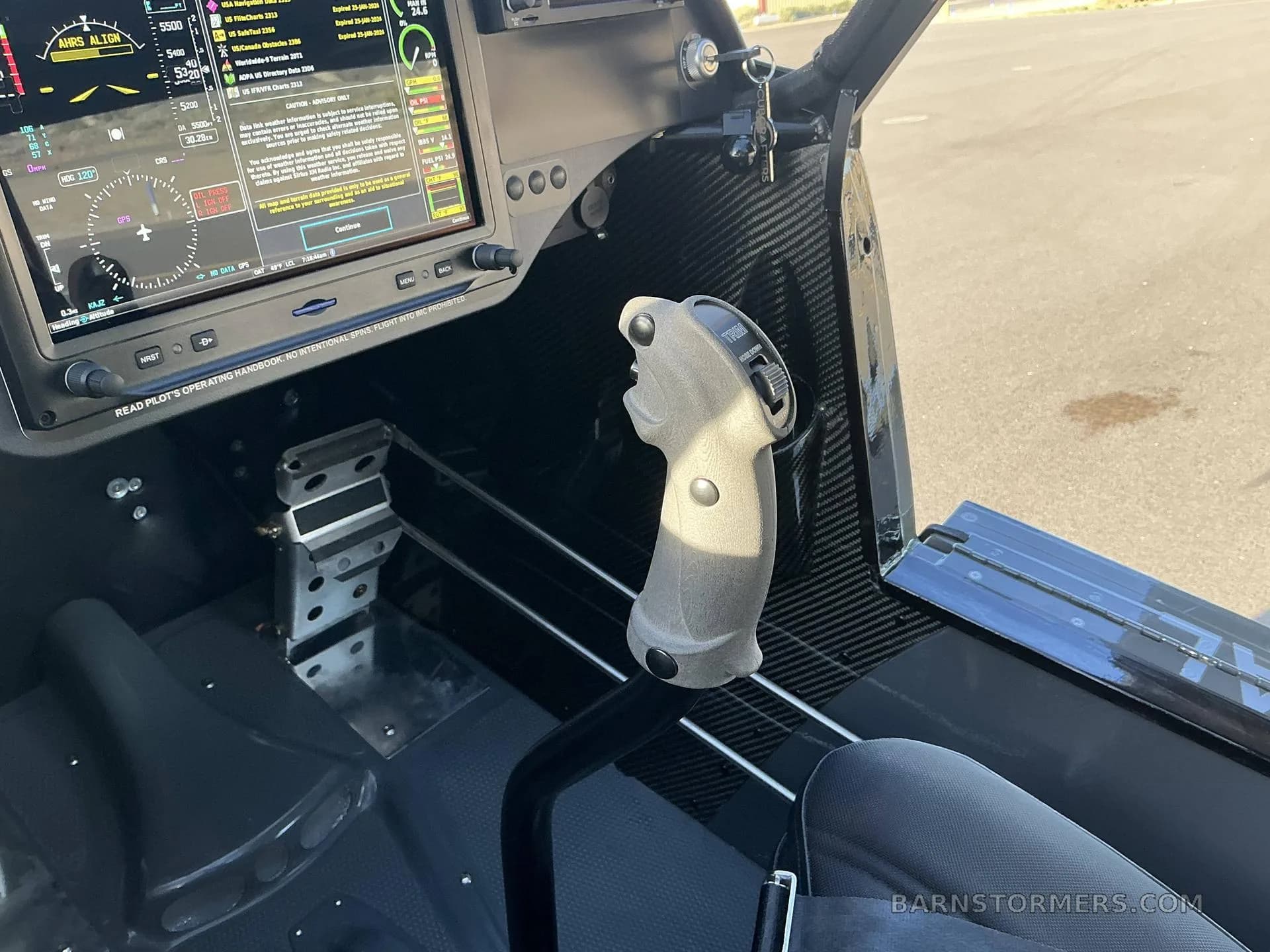 A close-up view of the stick and rudder pedals in the cockpit of a Carbon Cub FX3.