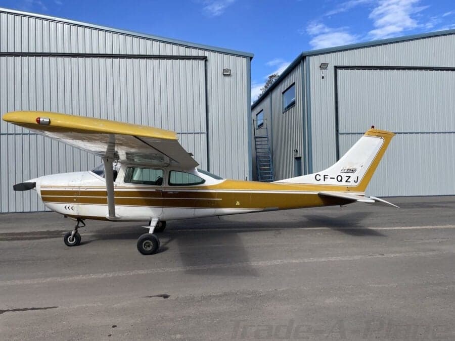 Cessna 182 Skylane parked in front of a hangar.