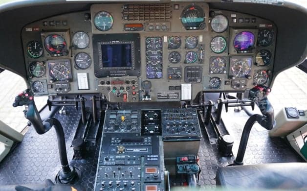 Interior view of the helicopter cabin with seats and medical equipment.