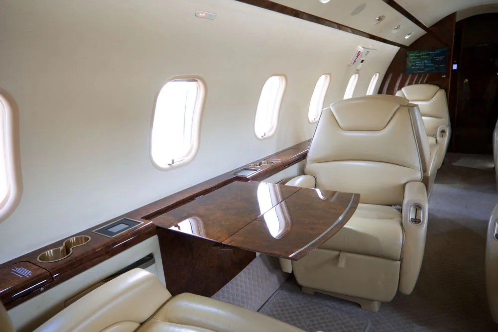View of the aircraft cabin showing cream-colored leather seats.