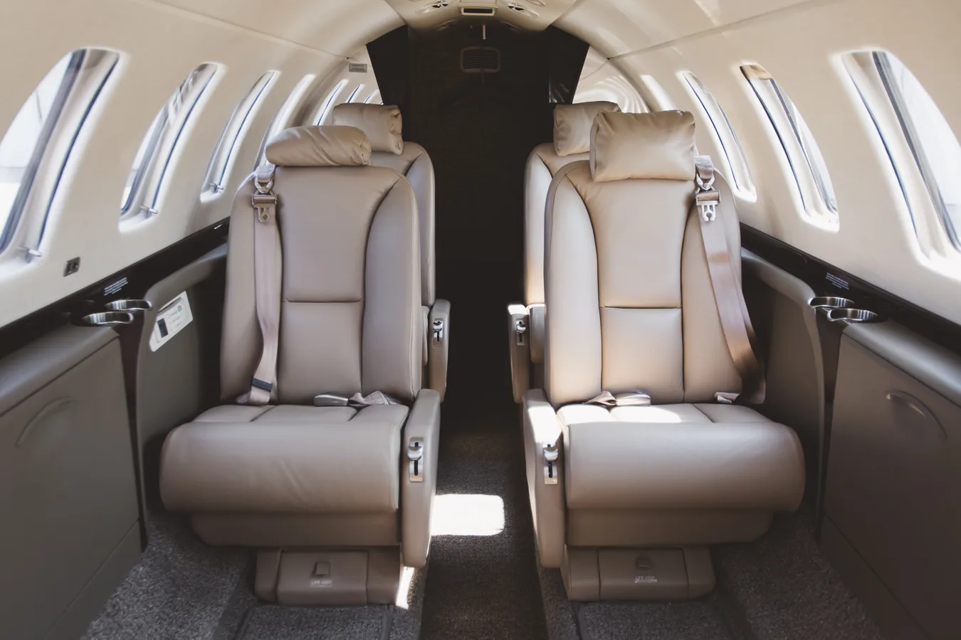 Close up of the aircraft cabin seats with seatbelts.