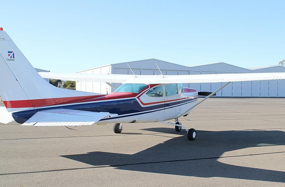 Side view of the aircraft on the tarmac with a red, white, and blue paint scheme.