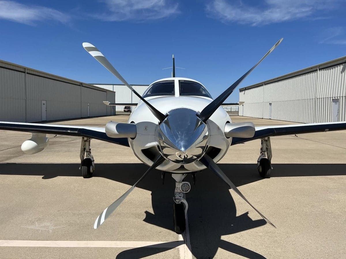 Front view of a Piper Meridian aircraft with its propeller blades prominently displayed.