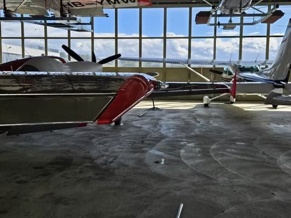 LY-EUG aircraft on the ground with a silver and red paint scheme.