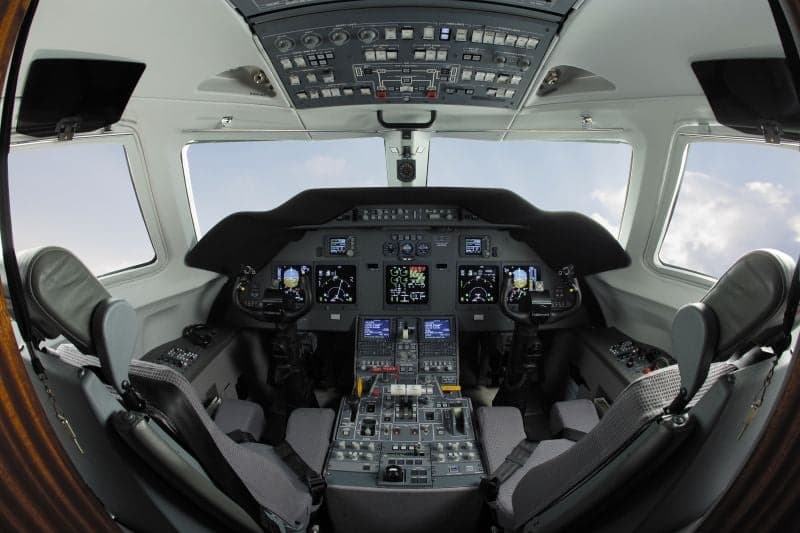 A view of the aircraft's interior, showing the seats and tables.