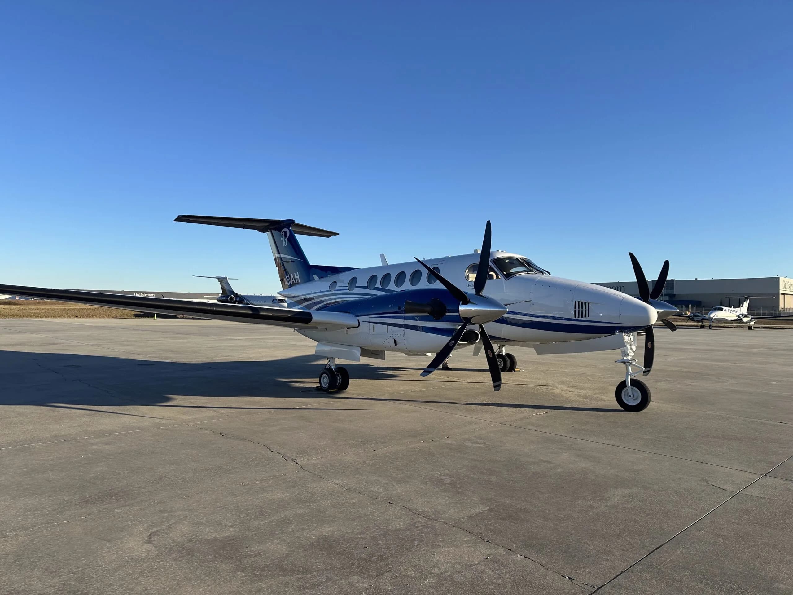 A Beechcraft King Air is parked on the tarmac.