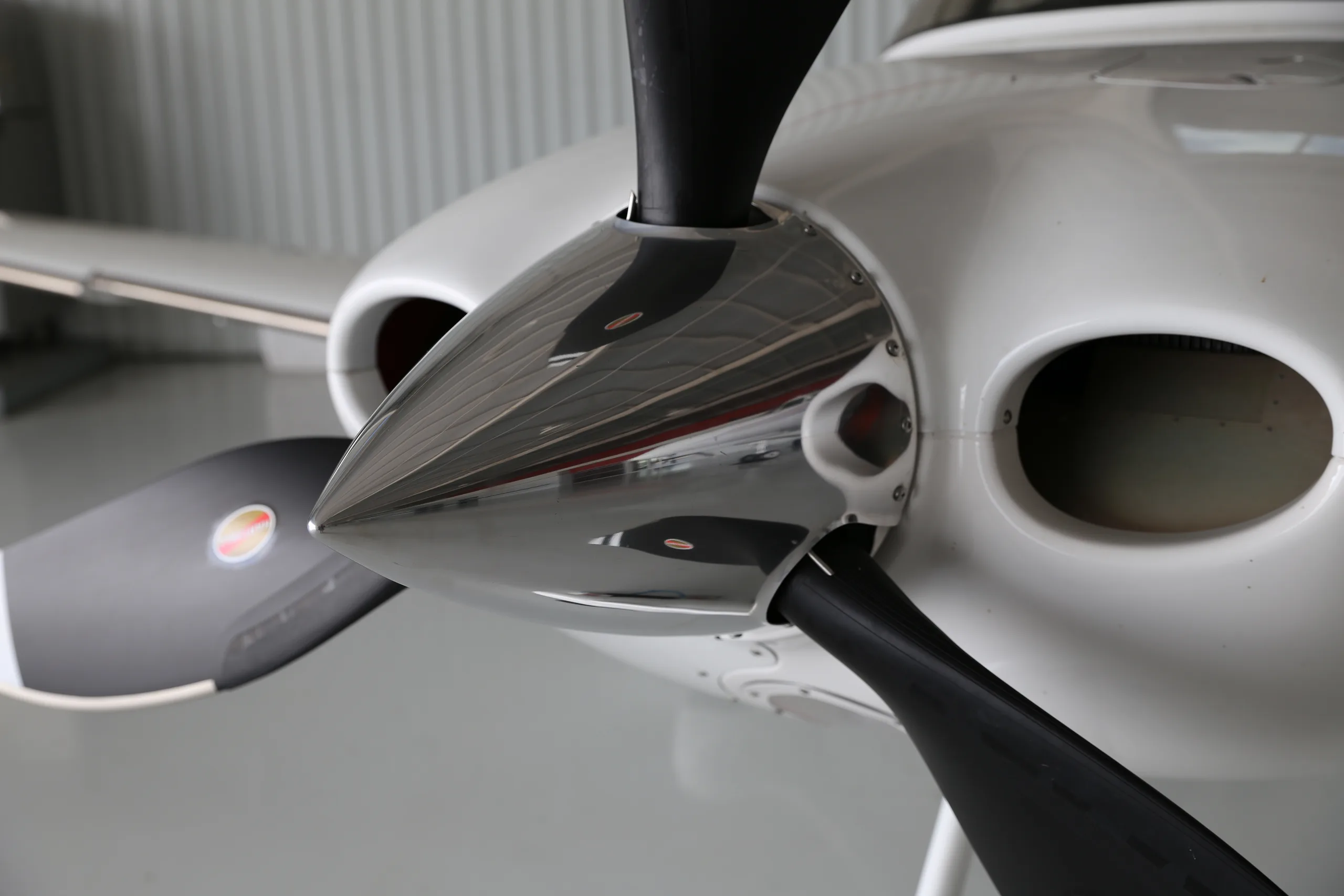 A close-up view of the polished spinner and black propeller blades of the Cirrus SR22T aircraft.