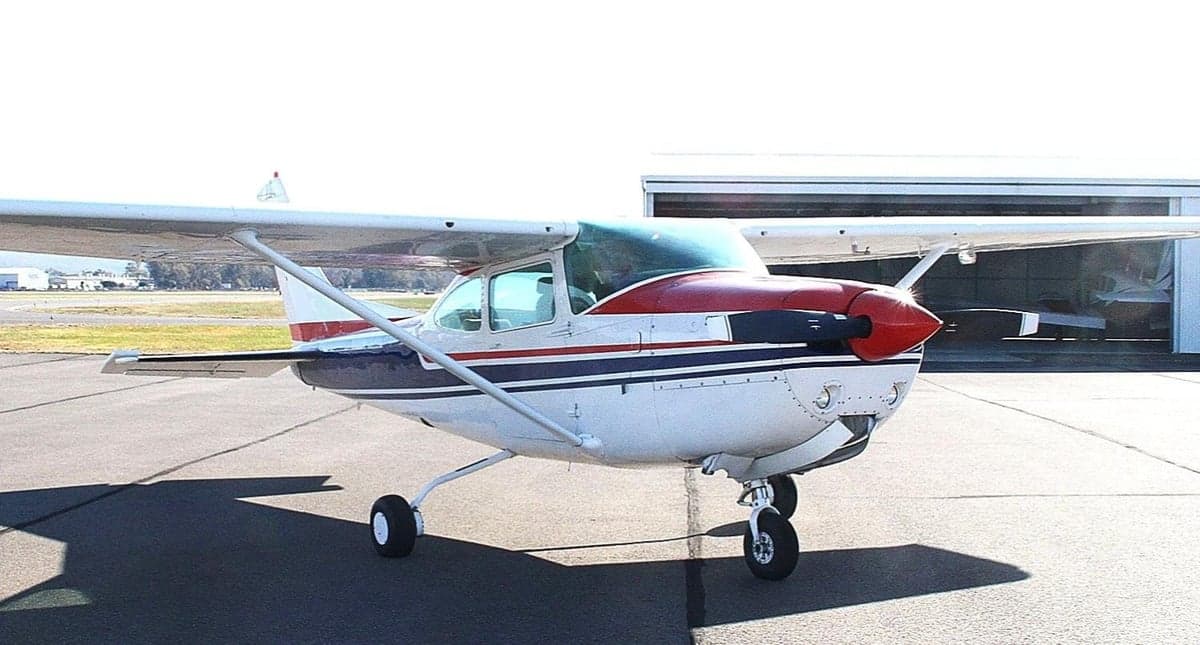 Side view of the aircraft on the tarmac with a red, white, and blue paint scheme.