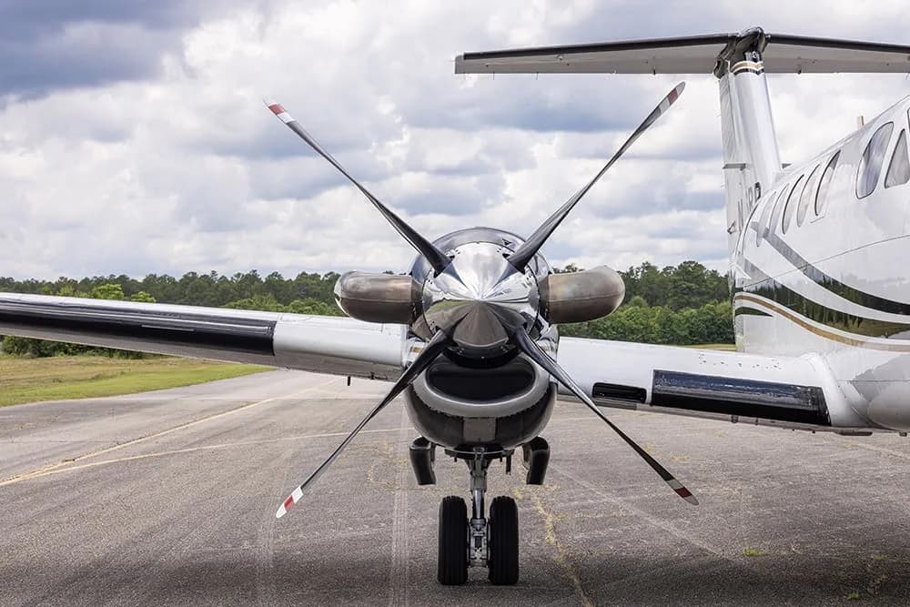 Front view of a King Air aircraft with registration N216RP showing the propellers and landing gear.