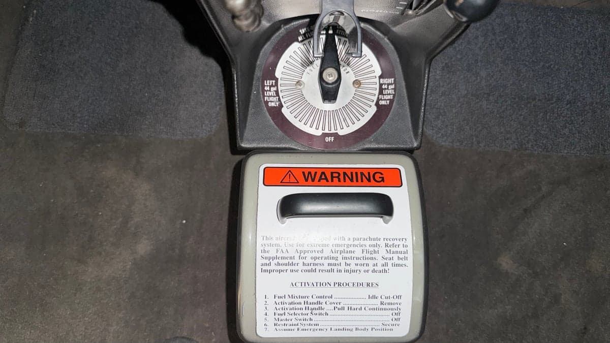 Close-up of the parachute activation instructions in the cockpit of N303BS.