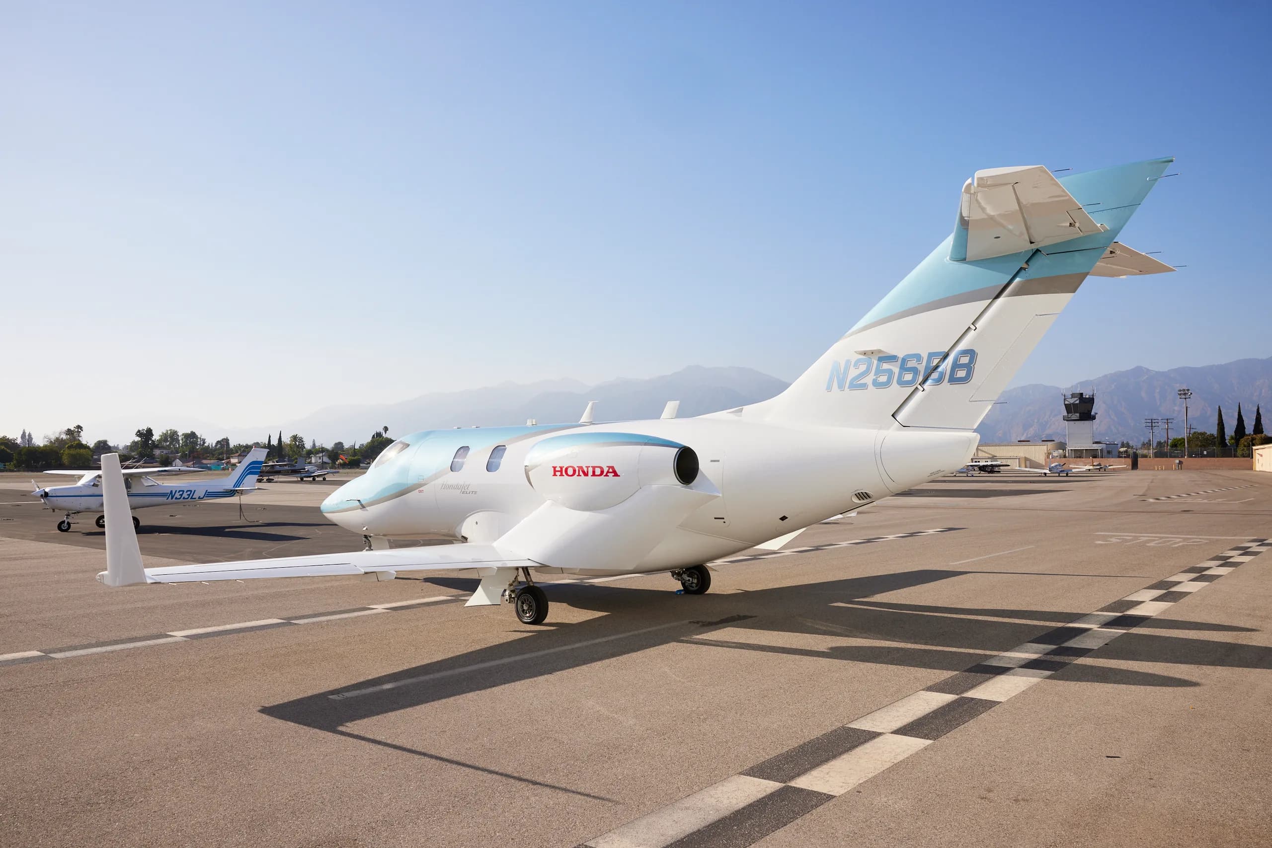 Rear view of a HondaJet Elite with registration N256BB at an airport.