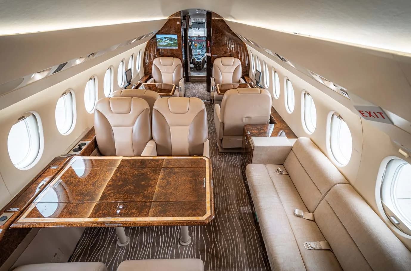 Interior view of the aircraft cabin with a table and sofa.