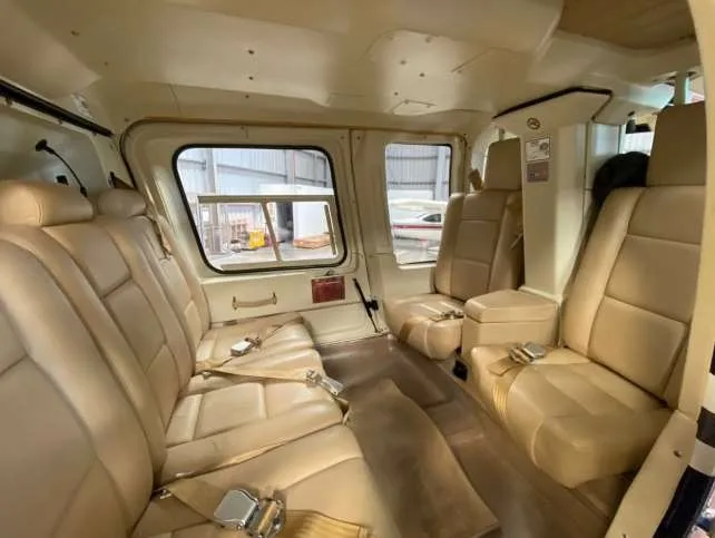 Interior view of the helicopter cabin with beige leather seats.