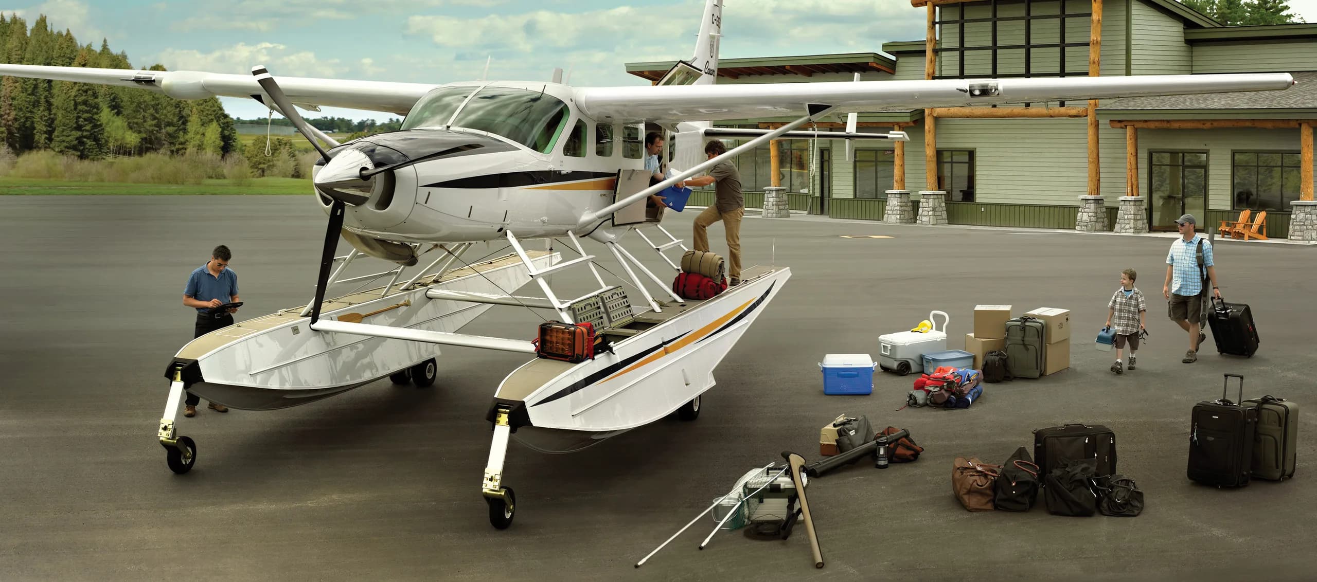 A Cessna Caravan seaplane being loaded with luggage.